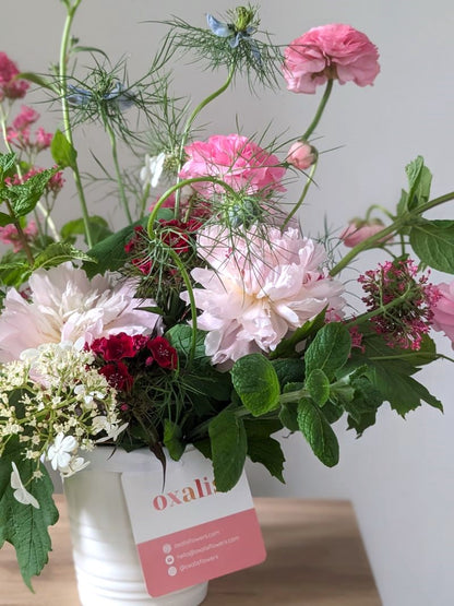 arrangement of spring flowers in pink, purple and blue