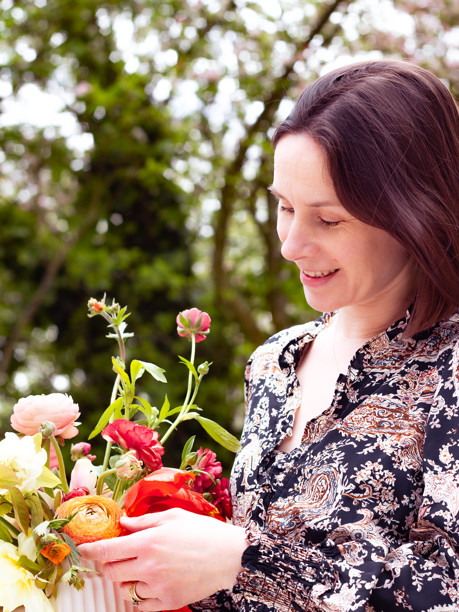 Image of Oxalis Flowers founder holding an arrangement of spring flowers