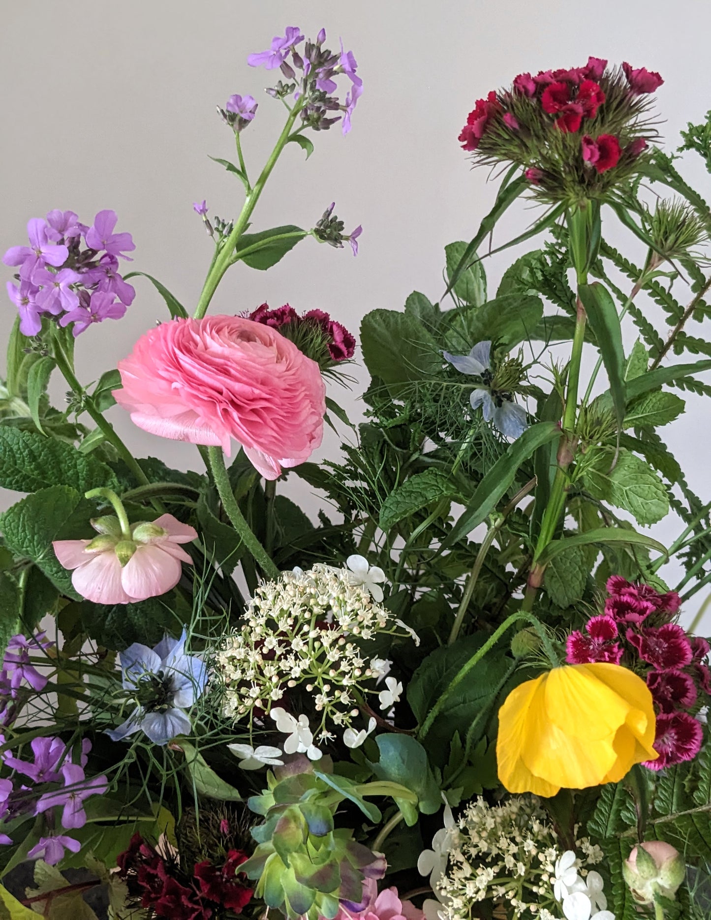 mix of spring flowers in pink purple and yellow