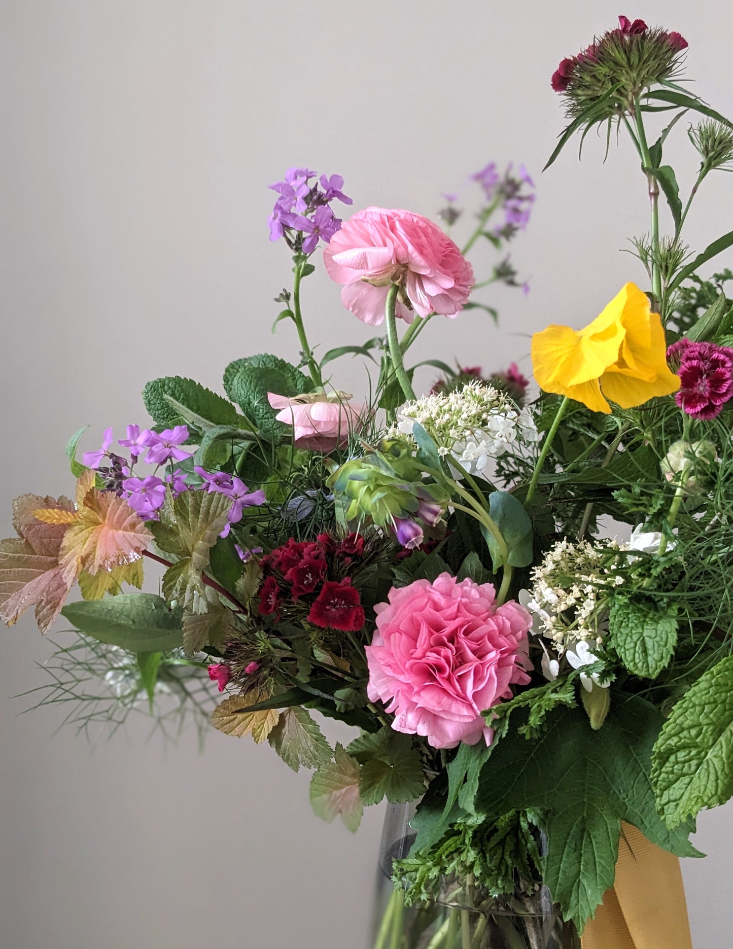 vase of spring flowers in pink purple and yellow