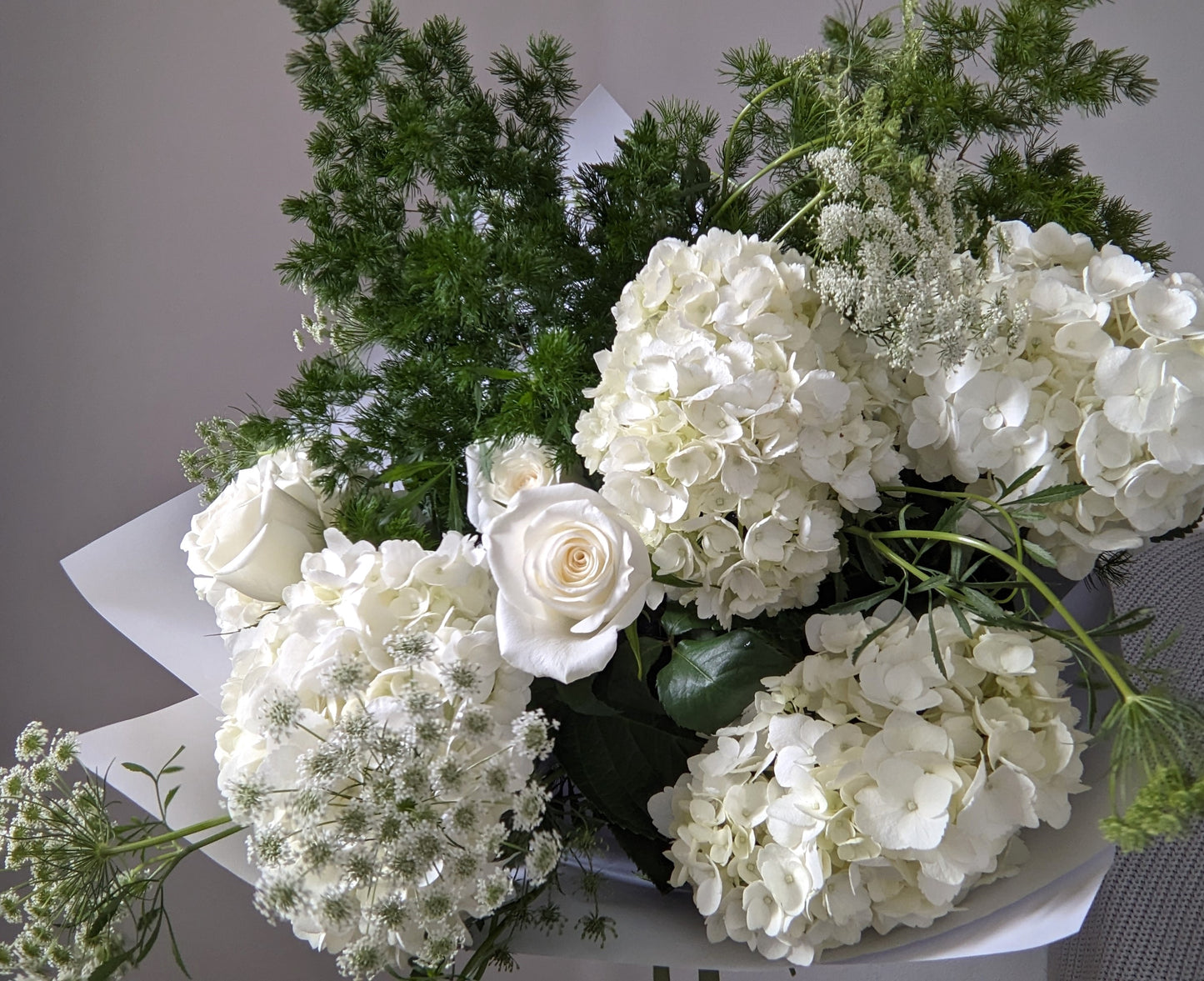 bouquet of white hydrangea, roses and ammi and greenery